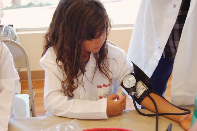 Little Medical School Ottawa. OpencityInc blog. Child using a blood pressure cuff.