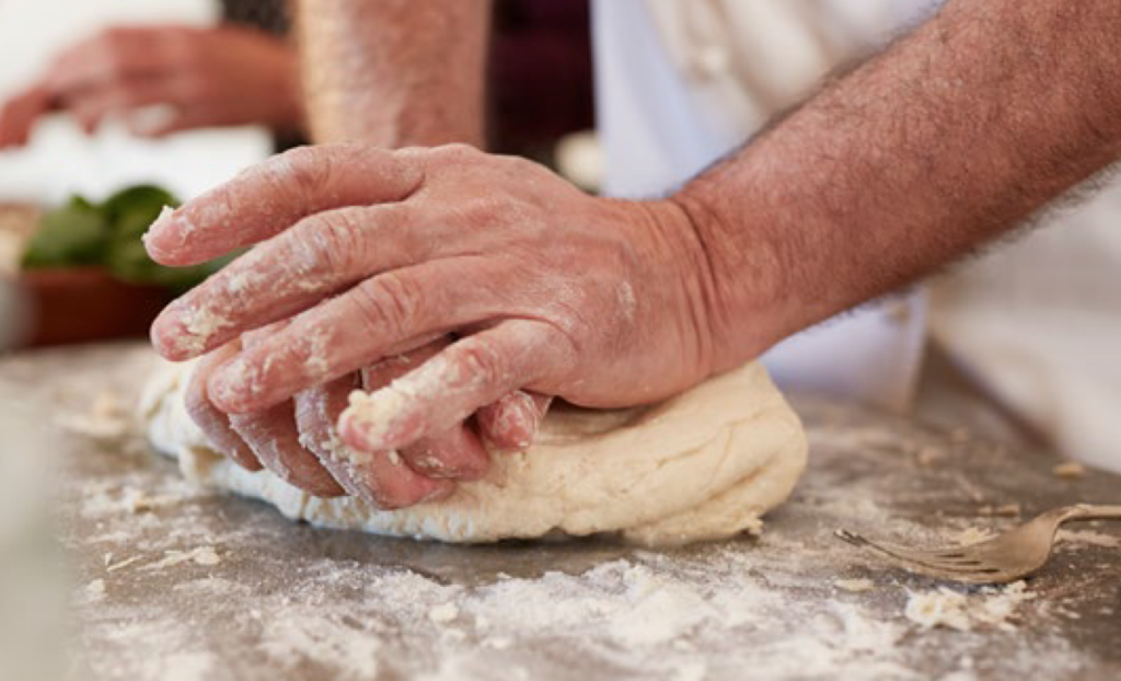 Older person making bread from The Future of Aging book